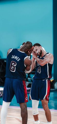 two basketball players standing next to each other on a court