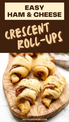 crescent rolls with ham and cheese in them on a cutting board