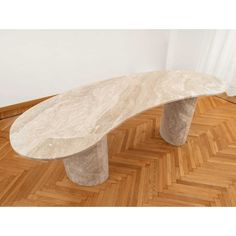 a marble bench sitting on top of a hard wood floor