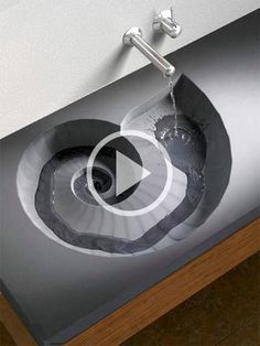 a sink that is in the middle of a counter top with water coming out of it