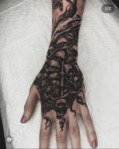 a person's hand with tattoos on it