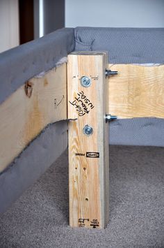 a wooden bed frame that has been made out of plywood planks and screws