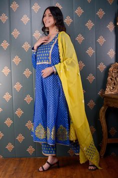 Royal blue anarkali with floral foil print and lace trim on the neckline and sleeve hems. Comes with palazzo and lemon yellow chanderi dupatta.
Component: 3
Pattern: Print and Embroidery
Type Of Work: Foil Print, Sequin and Thread
Neckline: Round
Sleeve Type: Full
Fabric: Anarkali: Banarasi Chanderi, Palazzo: Cotton Satin and Dupatta: Chanderi
Color: Blue
Other Details: 
Floral print dupatta with scalloped border
Lace trim on the neckline, bodice and sleeve hem
Occasion: Puja - Aza Fashions Royal Blue Anarkali, Chanderi Anarkali, Blue Anarkali, Chanderi Dupatta, Border Lace, Scalloped Border, Palazzo Set, Types Of Work, Blue Foil