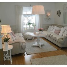 a living room filled with furniture and a white rug