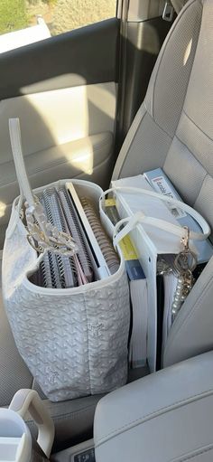 the back seat of a car with many items in it's pocket and other things inside