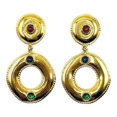 Vintage Givenchy Jewelled Hoop Earrings of statement proportions. Crafted from lustrous gold plated metal of superb quality and set with cabochon red, blue and green crystal stones emulating a luxury gold jewelled look. Signed, in very good vintage condition, 7cm. A truly outstanding pair of couture clips from the House of Givenchy. Should you choose to buy from us, we commit to the item being as described. Your vintage costume jewellery will arrive beautifully packaged and presented, helping to Gold Vintage Earrings, Givenchy Earrings, Vintage Gold Earrings, Givenchy Jewelry, Vintage Earring, Vintage Givenchy, Jeweled Earrings, Costume Earrings, Gold Statement Earrings