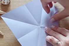 someone is making an origami umbrella out of paper