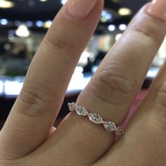 a woman's hand with a diamond ring on it