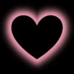 a heart shaped object in the dark with pink light coming from it's center