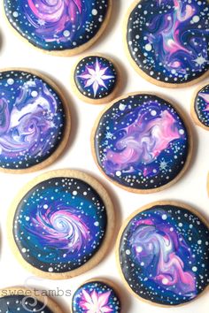 decorated cookies with stars and swirls are arranged on a white table top, ready to be eaten