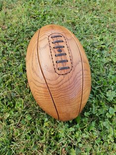 a close up of a wooden ball on some grass