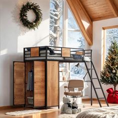 a loft bed with a desk and ladder in a room next to a christmas tree