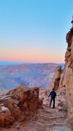 a man hiking up the side of a cliff