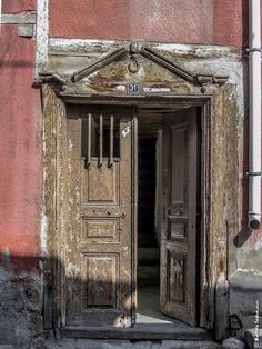 an old building with two wooden doors