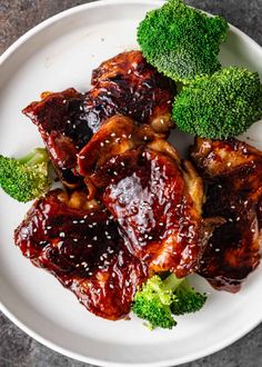 broccoli and meat on a white plate with sauce in the middle for garnish