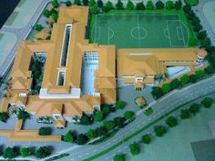 an aerial view of a soccer field and stadium in the middle of a model town