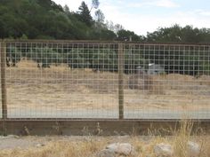 a fenced in area with some animals behind it