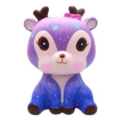 a purple and blue toy with horns on it's head sitting in front of a white background