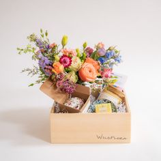 a wooden box filled with assorted flowers