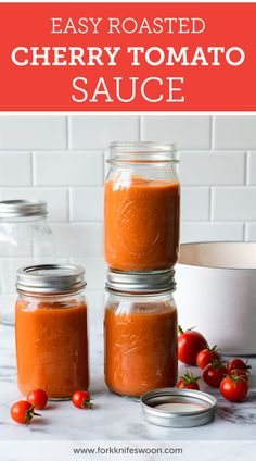 three jars filled with homemade cherry tomato sauce on top of a white counter next to tomatoes