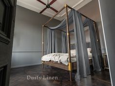 a canopy bed sitting in the middle of a bedroom