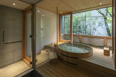 a large bath tub sitting inside of a bathroom next to a walk in shower stall