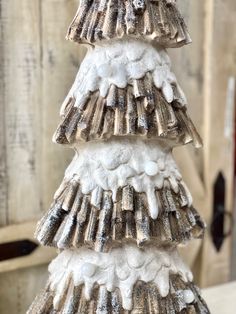 a small christmas tree made out of snow