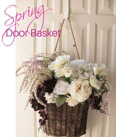 a basket filled with flowers hanging from the side of a white door next to a sign that says spring door basket