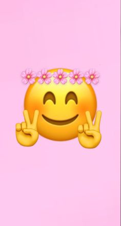 an emoticive smiley face with pink flowers on her head and fingers in the air