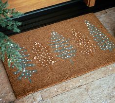 a door mat with christmas trees on it