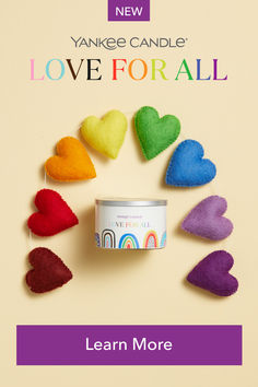 the yankee candle love for all is on display with hearts and rainbows around it