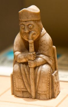 a clay figurine sitting on top of a wooden table