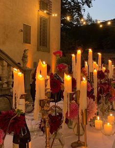 a table with candles and flowers on it