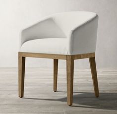 a white chair sitting on top of a wooden floor