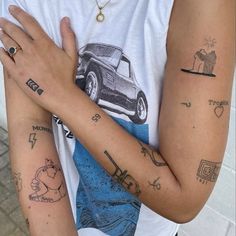 two people with matching tattoos on their arms