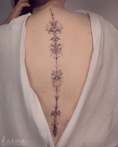 the back of a woman's neck with flowers on it