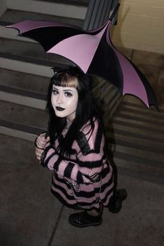 "Bleed pink.  -Gothic Umbrella.     -Black and Pastel Pink.  -Batwing Edging.     -Black Metal Hardware. -For Rain and Shine!    -34\" L x 33.5\" D.     -J-Shaped Handle. -Made of Nylon, Plastic, & Metal."