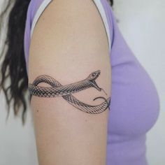 a woman with a snake tattoo on her arm