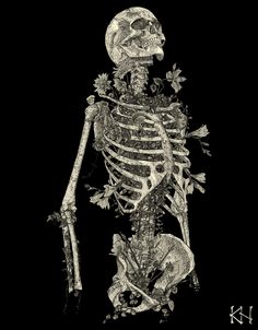 a black and white photo of a skeleton with flowers