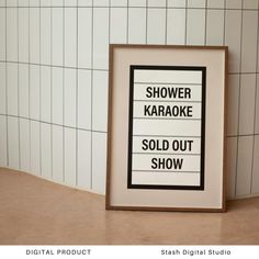 a sign that says shower karaoke sold out show in front of a tiled wall