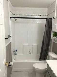 a bathroom with a toilet, sink and bathtub in it's shower stall