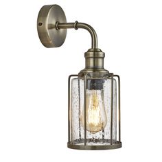 an old fashioned wall light with a clear glass shade