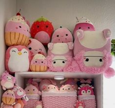 a shelf filled with lots of stuffed animals and other stuff animal items on top of it