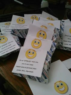 several envelopes with emoticions on them sitting on top of a wooden table