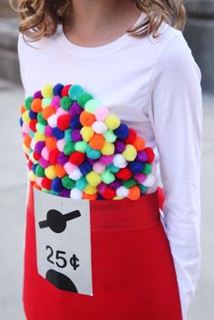 a woman is wearing a red skirt with colorful pom - poms on it