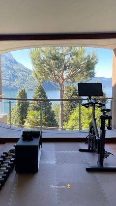 there is a gym with treadmills and exercise equipment in front of a large window