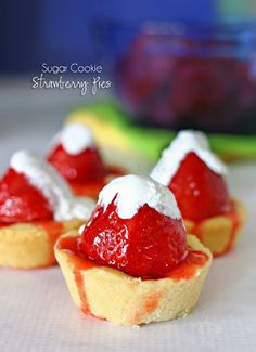 mini strawberry shortcakes are topped with whipped cream and fresh strawberries on top