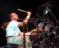 a man is playing drums on stage