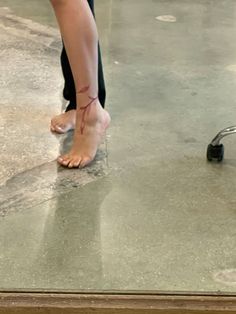 a person with bare feet standing on the ground