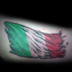 an italian flag tattoo on the left side of the arm, with torn pieces in green and red